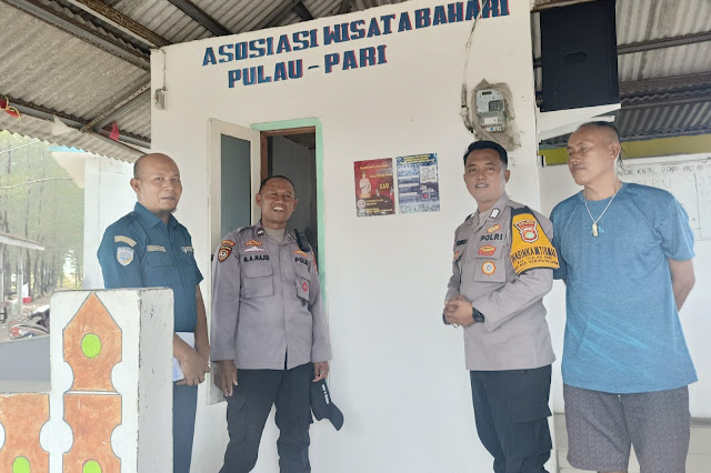 📸 Aparat gabungan (termasuk personel Polisi dengan nama 'SUHENDI') bersama petugas PMI dan warga saat mendistribusikan bantuan kepada korban rob di Kelurahan Pulau Panggang pada 7 Desember 2025. Genangan air terlihat memasuki area pemukiman warga.