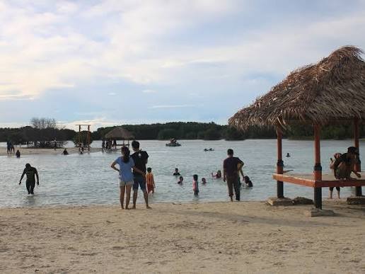 Suasana santai keluarga menikmati air jernih dan pasir putih lembut di Pantai Pasir Perawan, Pulau Pari. (Foto: Istimewa)